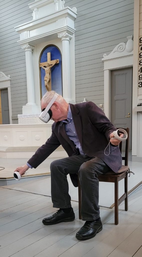 Participant playing VR game at Sammaljoki church.